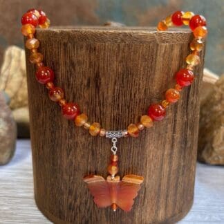 an image of a Carnelian and Sterling Silver Beaded Butterfly Necklace. It has mixed round and faceted beads with a hand carved butterfly pendant.