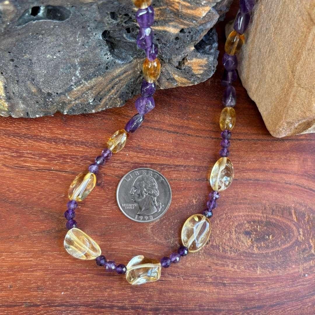 an image of a Citrine and Amethyst Beaded Necklace with citrine smooth nuggets, citrine barrel beads and 4 mm faceted amethyst and amethyst smooth nuggets. The necklace is 19.75 inches long. This image is next to a quarter