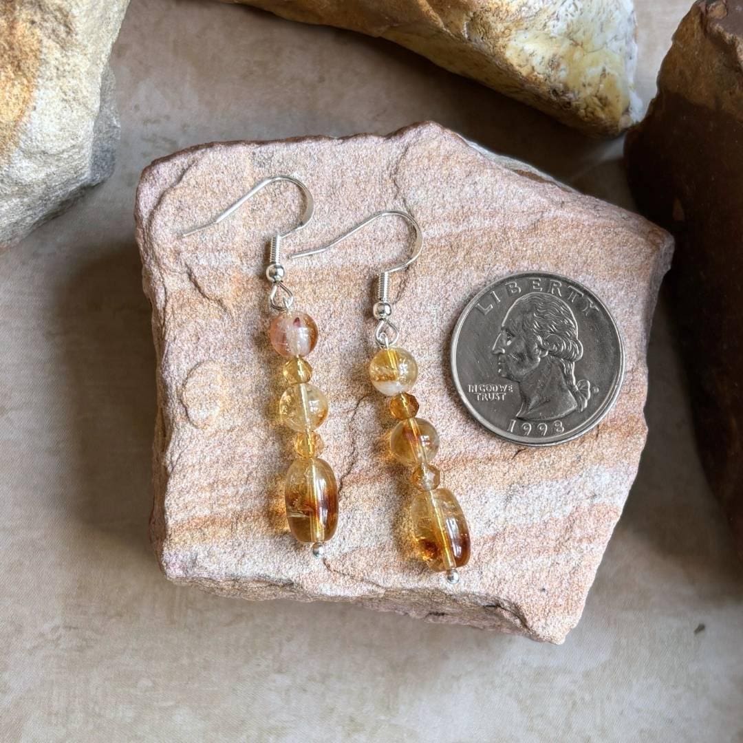 an image of a pair of Citrine Barrel and Round Beaded Earrings next to a quarter